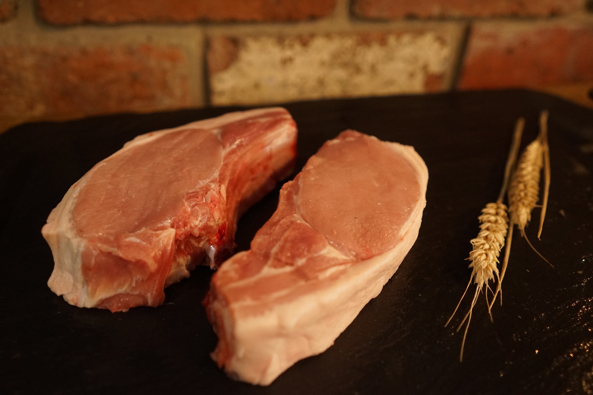 2 Pork Chops on a slate chopping board