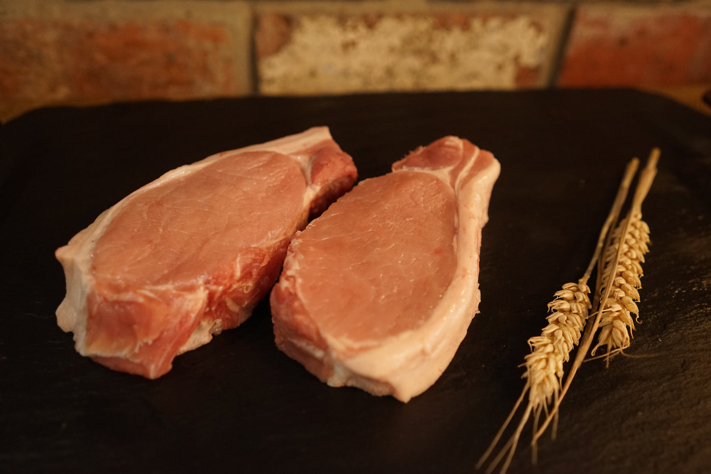 2 Pork Loin Steaks on a slate chopping board