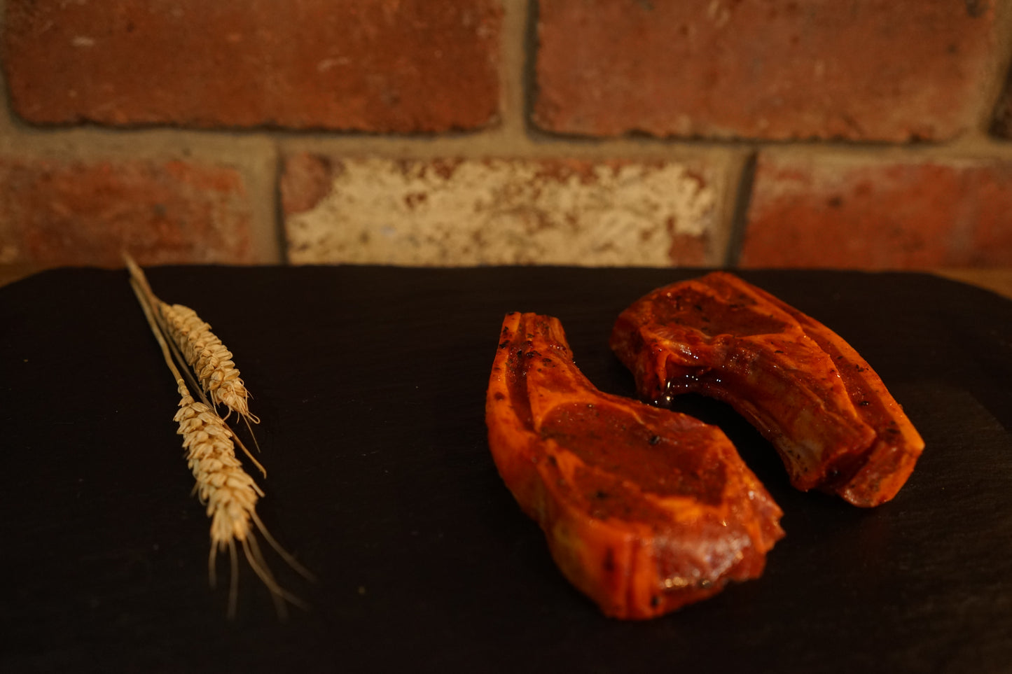 2 Tandoori marinated Lamb Cutlets on a slate chopping board