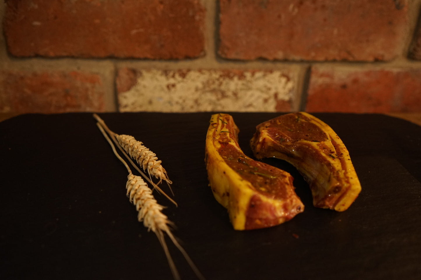 2 Thai marinated Lamb Cutlets on a slate chopping board