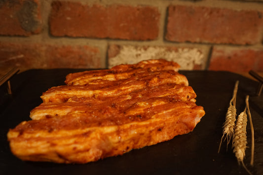 4 BBQ marinated Meaty Pork Ribs on a slate chopping board