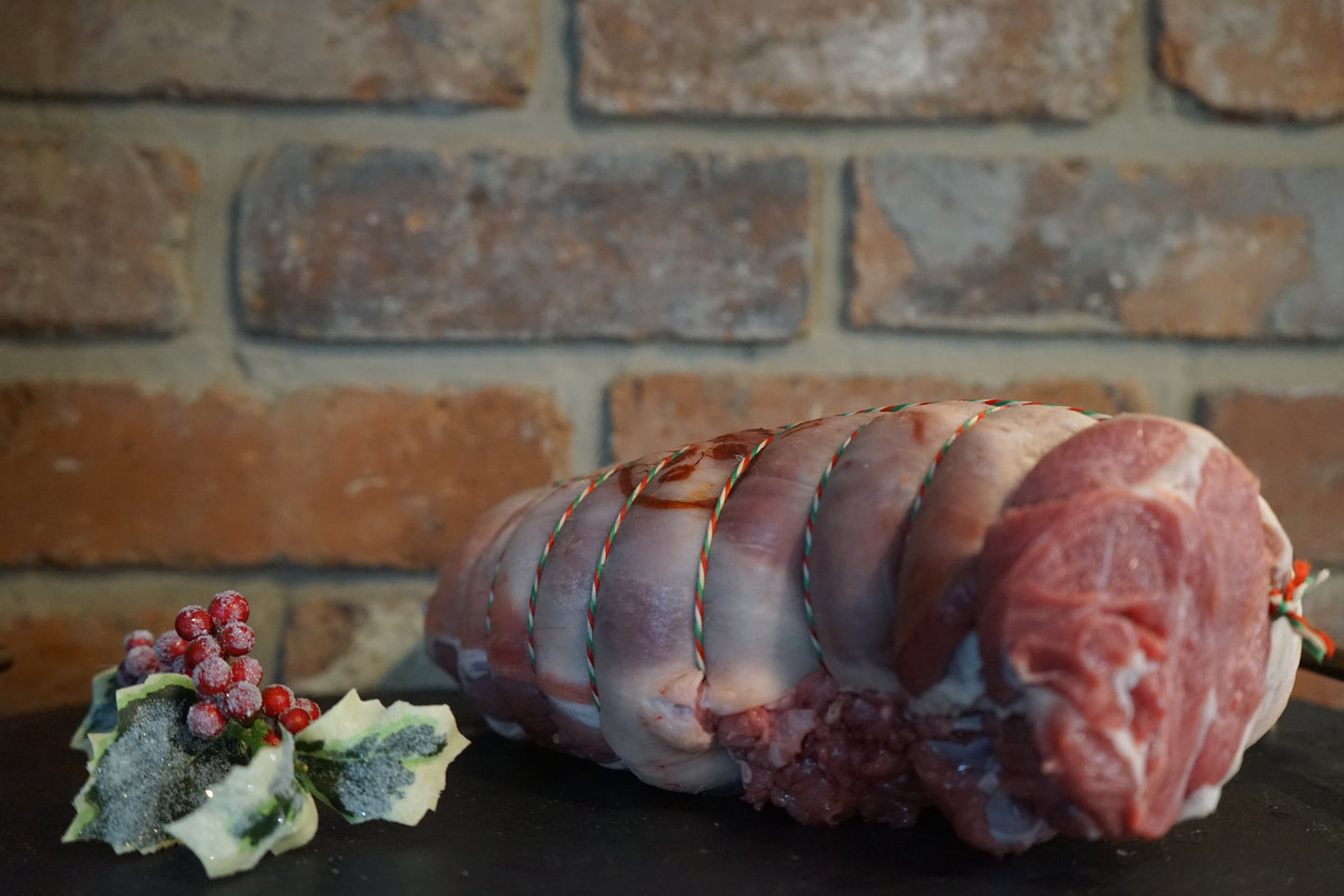 A Boneless Gigot of Lamb on a slate chopping board