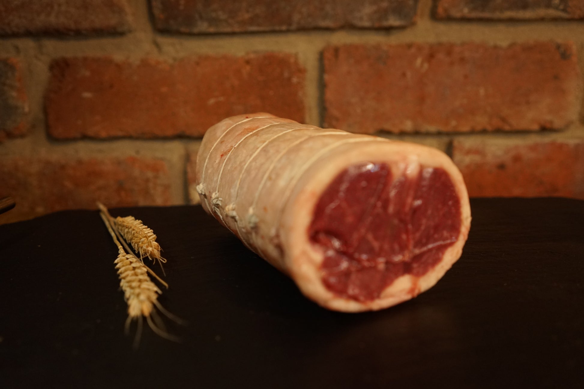 A Boneless Short Saddle Roast on a slate chopping board 