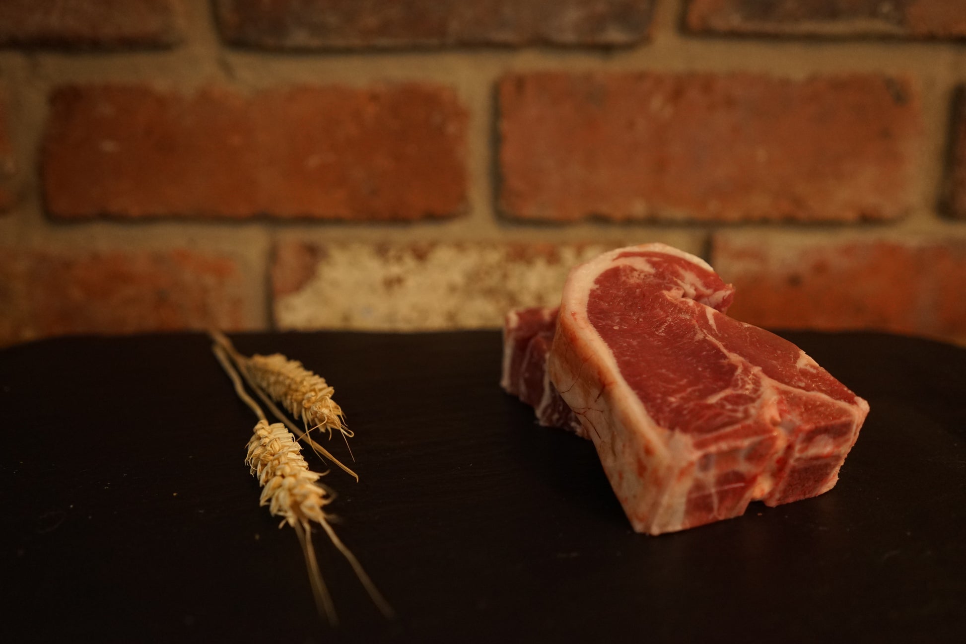 2 Lamb Chops on a slate chopping board