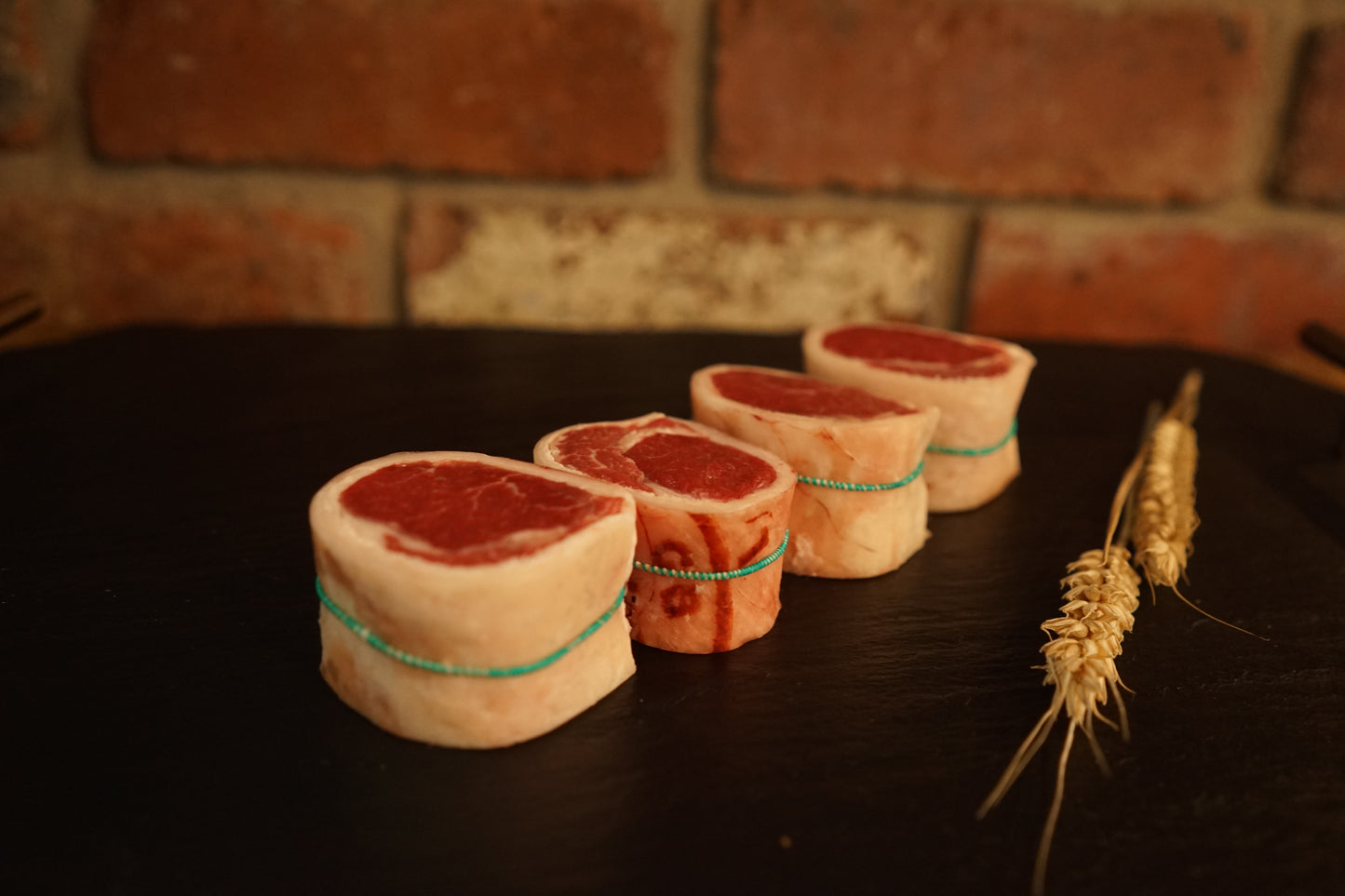 4 Lamb Noisettes on a slate chopping board