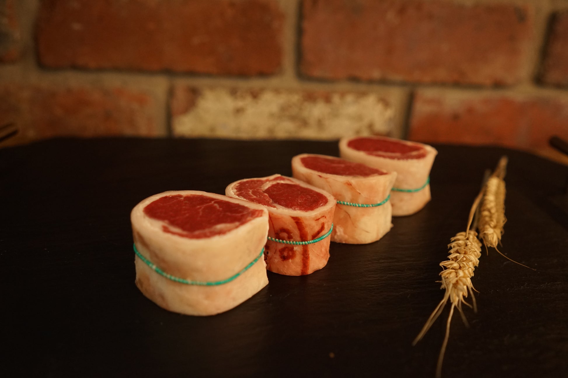 4 Lamb Noisettes on a slate chopping board