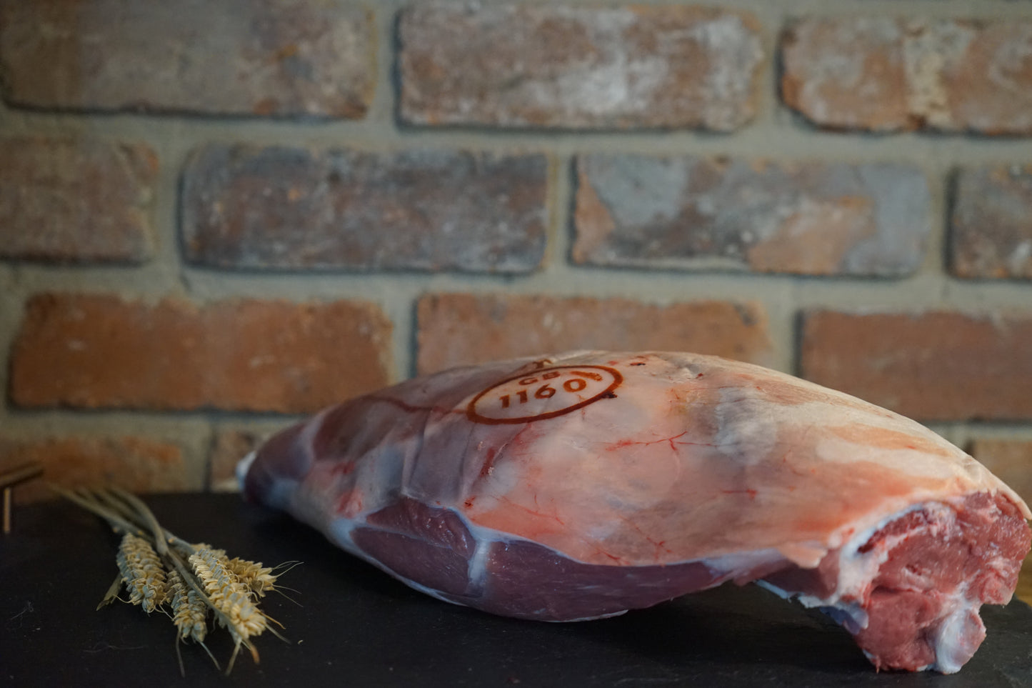 A large Leg of Lamb on a slate chopping board