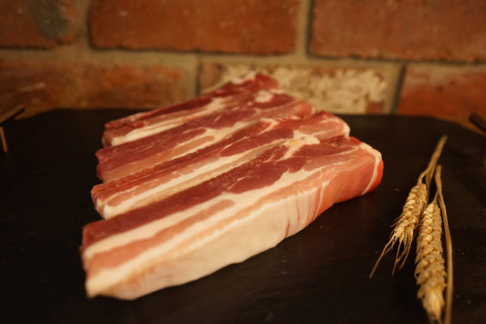 4 Meaty Pork Ribs on a slate chopping board