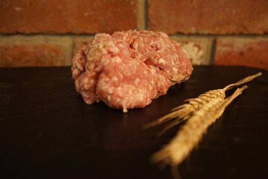 A small portion of Pork Sausage Meat on a slate chopping board 