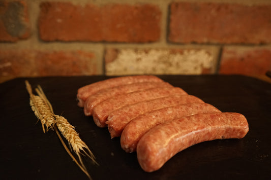 6 Pork Sausages on a slate chopping board