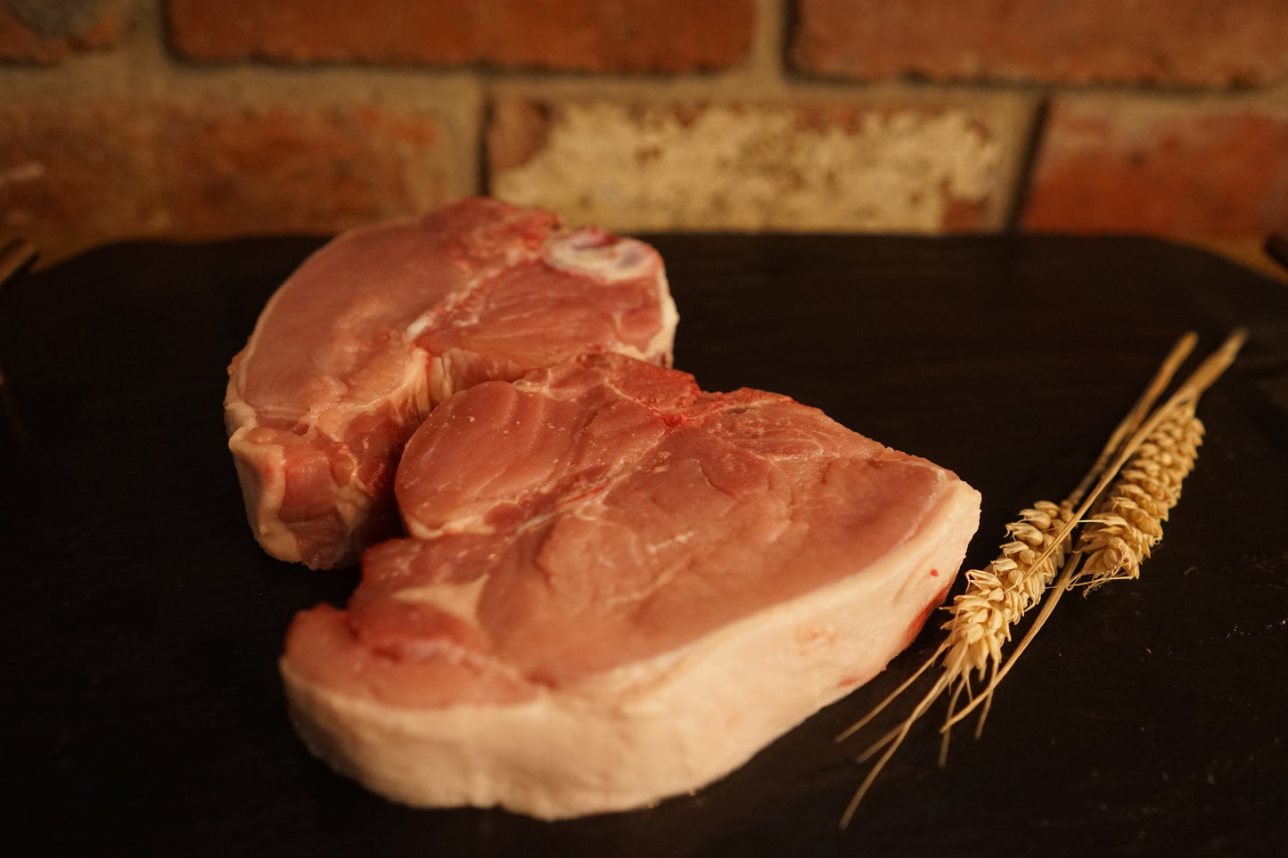 2 Pork T-bones on a slate chopping board